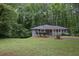 Charming home featuring a well-maintained front yard and lush trees at 2383 Edgewater Sw Dr, Atlanta, GA 30311