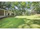 View of the expansive front yard, showcasing the well-manicured lawn and mature trees surrounding the property at 2383 Edgewater Sw Dr, Atlanta, GA 30311