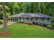 Charming single-story home with a well-manicured lawn, front porch, and lush landscaping at 2383 Edgewater Sw Dr, Atlanta, GA 30311