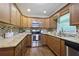 Modern kitchen with stainless appliances, sleek granite countertops, and stylish tiled backsplash at 2383 Edgewater Sw Dr, Atlanta, GA 30311