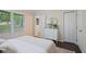 Cozy bedroom with warm hardwood floors, a dresser, and a view of the lovely outdoor scenery at 2383 Edgewater Sw Dr, Atlanta, GA 30311