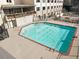 Outdoor swimming pool with a brick border, surrounded by fencing and lounge areas at 2479 Peachtree Ne Rd # 605, Atlanta, GA 30305