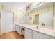 This bathroom has a double vanity, framed mirror, and linen cabinets at 4512 Orchard Trce, Roswell, GA 30076