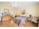 This light-filled bedroom features a ceiling fan, artwork and bamboo flooring at 4512 Orchard Trce, Roswell, GA 30076