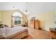Sun-filled bedroom with vaulted ceiling, large window, and warm tones, offering a relaxing retreat at 4512 Orchard Trce, Roswell, GA 30076