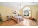 Inviting bedroom with a large window, ceiling fan, and wood-look flooring, creating a comfortable and serene atmosphere at 4512 Orchard Trce, Roswell, GA 30076