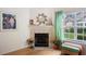 Living room with fireplace, large windows, and bright natural light at 4512 Orchard Trce, Roswell, GA 30076