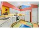 Charming kitchen featuring white cabinets, laminate countertops, and colorful accents and decorations throughout the room at 4512 Orchard Trce, Roswell, GA 30076