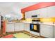 Functional kitchen featuring essential appliances, breakfast bar, and colorful decor, with easy access to the dining area at 4512 Orchard Trce, Roswell, GA 30076