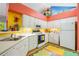 Bright kitchen featuring white appliances, laminate countertops, colorful accents and a playful decorated ceiling at 4512 Orchard Trce, Roswell, GA 30076