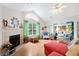 Cozy living room with fireplace, large window and view to the enclosed porch at 4512 Orchard Trce, Roswell, GA 30076