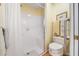 This bright shower features white tile, a grab bar, and a corner seat at 4512 Orchard Trce, Roswell, GA 30076