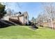 Expansive backyard with lush lawn, landscaping, and an outdoor entertaining area at 9360 Nesbit Lakes Dr, Alpharetta, GA 30022