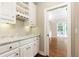 Well-appointed bar area with marble countertop, wine rack, and custom cabinets at 9360 Nesbit Lakes Dr, Alpharetta, GA 30022