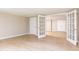 Finished basement with neutral walls, wood-look flooring, and glass doors at 9360 Nesbit Lakes Dr, Alpharetta, GA 30022