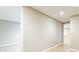 Finished basement area with wood-look flooring and a drop ceiling, offering versatile space at 9360 Nesbit Lakes Dr, Alpharetta, GA 30022