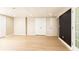 Basement with wood-look flooring, neutral walls, and closet space at 9360 Nesbit Lakes Dr, Alpharetta, GA 30022