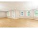 Light-filled finished basement with multiple windows, recessed lighting, and access to the backyard at 9360 Nesbit Lakes Dr, Alpharetta, GA 30022