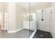 Bright bathroom featuring a glass enclosed shower, a double vanity and tile flooring at 9360 Nesbit Lakes Dr, Alpharetta, GA 30022