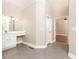 View of the bathroom with a vanity, tile floors, and doorway leading to another room at 9360 Nesbit Lakes Dr, Alpharetta, GA 30022