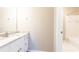 Bathroom with white vanity, marble countertop and a doorway to the shower at 9360 Nesbit Lakes Dr, Alpharetta, GA 30022