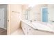 Bathroom featuring a spacious vanity with marble countertop and a large mirror, offering contemporary style at 9360 Nesbit Lakes Dr, Alpharetta, GA 30022