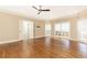 Bedroom with a ceiling fan, hardwood floors, and access to an outdoor area at 9360 Nesbit Lakes Dr, Alpharetta, GA 30022