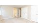 Bedroom with neutral carpet, white double doors, and an adjacent bathroom at 9360 Nesbit Lakes Dr, Alpharetta, GA 30022