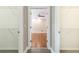 View from inside closet looking to bedroom with ceiling fan and wood flooring at 9360 Nesbit Lakes Dr, Alpharetta, GA 30022