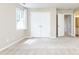 Bedroom with neutral walls, carpet flooring, double closet doors, and an open doorway to an en-suite bath at 9360 Nesbit Lakes Dr, Alpharetta, GA 30022
