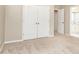 Bedroom with neutral carpet and double doors opening to an en-suite bath at 9360 Nesbit Lakes Dr, Alpharetta, GA 30022