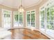 Bright breakfast nook with large windows, hardwood floors, and access to outdoor deck at 9360 Nesbit Lakes Dr, Alpharetta, GA 30022