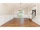 Spacious dining room boasting hardwood floors, wainscoting, and large windows at 9360 Nesbit Lakes Dr, Alpharetta, GA 30022