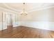 Bright dining room showcasing hardwood floors, a chandelier, and French doors at 9360 Nesbit Lakes Dr, Alpharetta, GA 30022