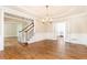 Elegant dining room featuring hardwood floors, decorative chandelier and stair access at 9360 Nesbit Lakes Dr, Alpharetta, GA 30022