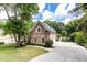 Long driveway leading to the brick home with well-maintained landscaping at 9360 Nesbit Lakes Dr, Alpharetta, GA 30022