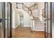 Inviting foyer with hardwood floors, staircase, and natural light streaming through the glass front door at 9360 Nesbit Lakes Dr, Alpharetta, GA 30022