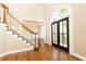 Grand foyer with hardwood floors, staircase and arched entry at 9360 Nesbit Lakes Dr, Alpharetta, GA 30022