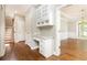 Inviting hallway featuring a built-in desk and stairs leading to the upper level at 9360 Nesbit Lakes Dr, Alpharetta, GA 30022