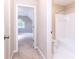 Hallway featuring an open bathroom on the right and a bedroom view in the background at 9360 Nesbit Lakes Dr, Alpharetta, GA 30022