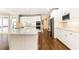 Bright kitchen featuring white cabinets, stainless steel appliances, and hardwood floors at 9360 Nesbit Lakes Dr, Alpharetta, GA 30022