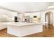 Bright kitchen featuring white cabinets, stainless steel appliances, an island and hardwood floors at 9360 Nesbit Lakes Dr, Alpharetta, GA 30022