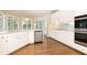 Bright kitchen with stainless steel appliances, white cabinets, a hardwood floor, and many windows at 9360 Nesbit Lakes Dr, Alpharetta, GA 30022