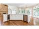 Bright kitchen featuring white cabinets, stainless steel appliances, hardwood floors, and a wine cooler at 9360 Nesbit Lakes Dr, Alpharetta, GA 30022