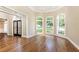 Bright living room with hardwood floors, large arched windows and trim at 9360 Nesbit Lakes Dr, Alpharetta, GA 30022