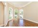 Sun-filled living room with hardwood floors, arched windows and custom trim at 9360 Nesbit Lakes Dr, Alpharetta, GA 30022