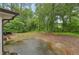 Backyard featuring a cracked concrete patio area and picnic table at 1849 Clay Sw Rd, Mableton, GA 30126