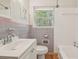 Bathroom featuring a clean white vanity, combined shower and tub and a window at 1849 Clay Sw Rd, Mableton, GA 30126