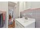 Bathroom featuring a clean white vanity and pink and gray tile at 1849 Clay Sw Rd, Mableton, GA 30126