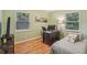 Comfortable bedroom with hardwood floors, a cozy bed, and natural light at 1849 Clay Sw Rd, Mableton, GA 30126